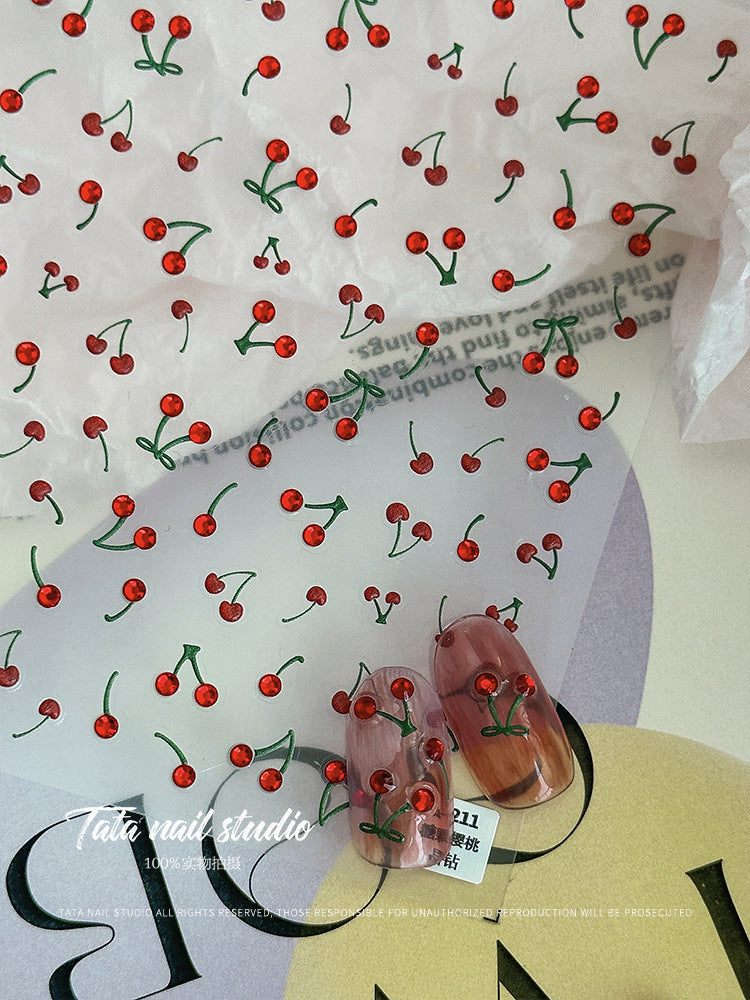 Cherry nail stickers with glossy red fruit design applied on clear sample nails.