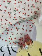 Cherry nail stickers with glossy red fruit design applied on clear sample nails.