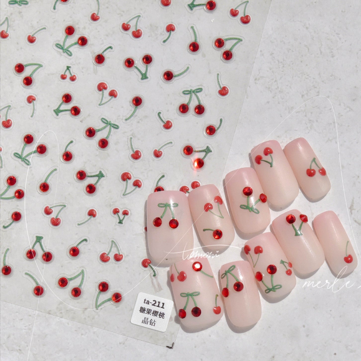 Nail art with cherry designs on a light background