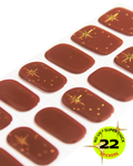 Rust brown nail wrap stickers with gold star accents.