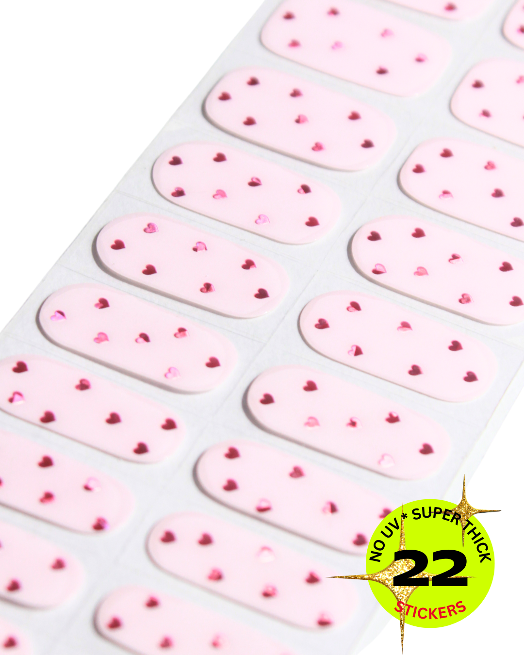 “Sheet of pale pink nail stickers decorated with small heart shapes”