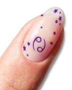 Nail with purple zodiac symbol and stars on a white background