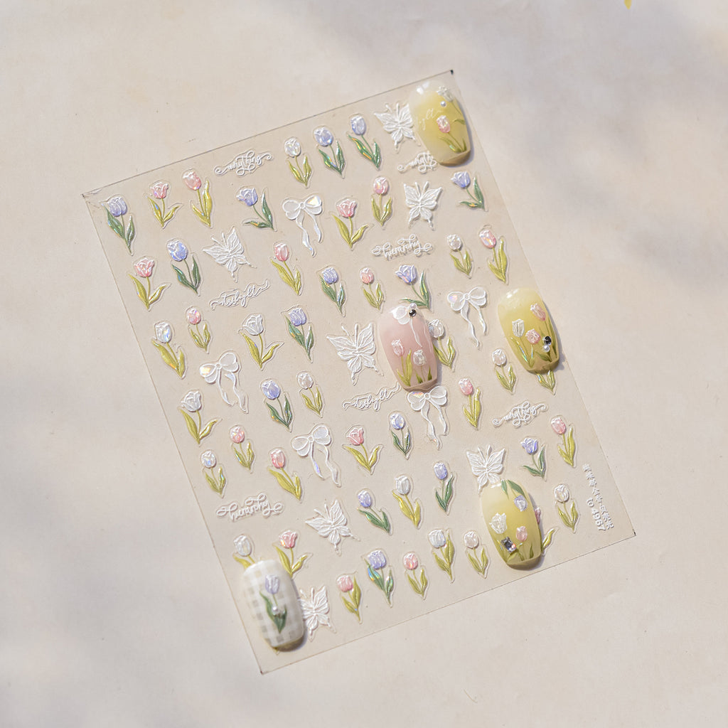 Sheet of decorative nail art stickers with flowers and butterflies on a beige background