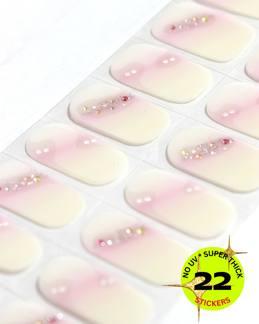 Sheet of nail wrap with a gradient design and glitter, labeled '22 no UV super thick stickers'.