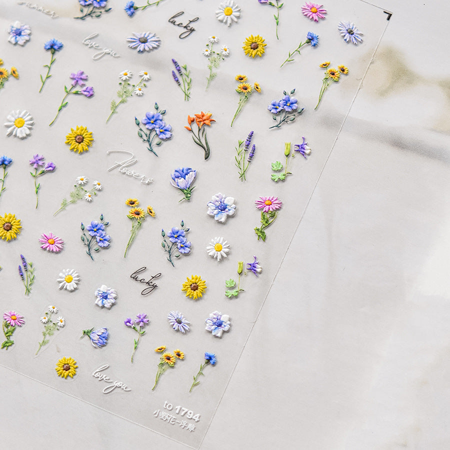 Collection of colorful floral stickers on a light background