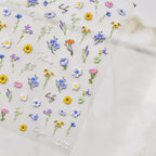 Collection of colorful floral stickers on a light background