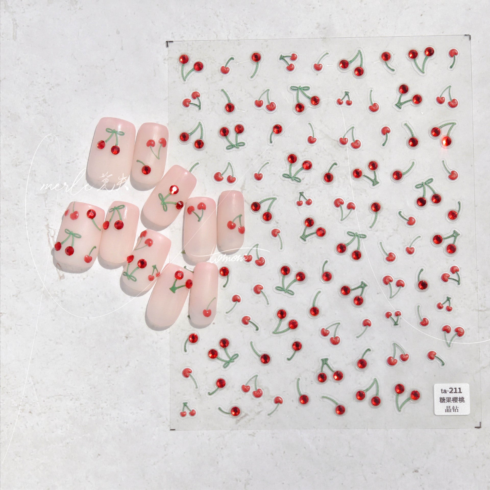 Nail art with cherry designs on a textured white background