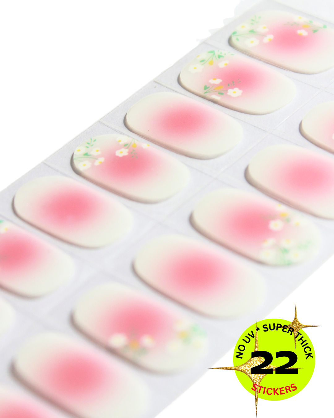 Blush aura nail wrap with delicate flower details, soft gradient manicure.
