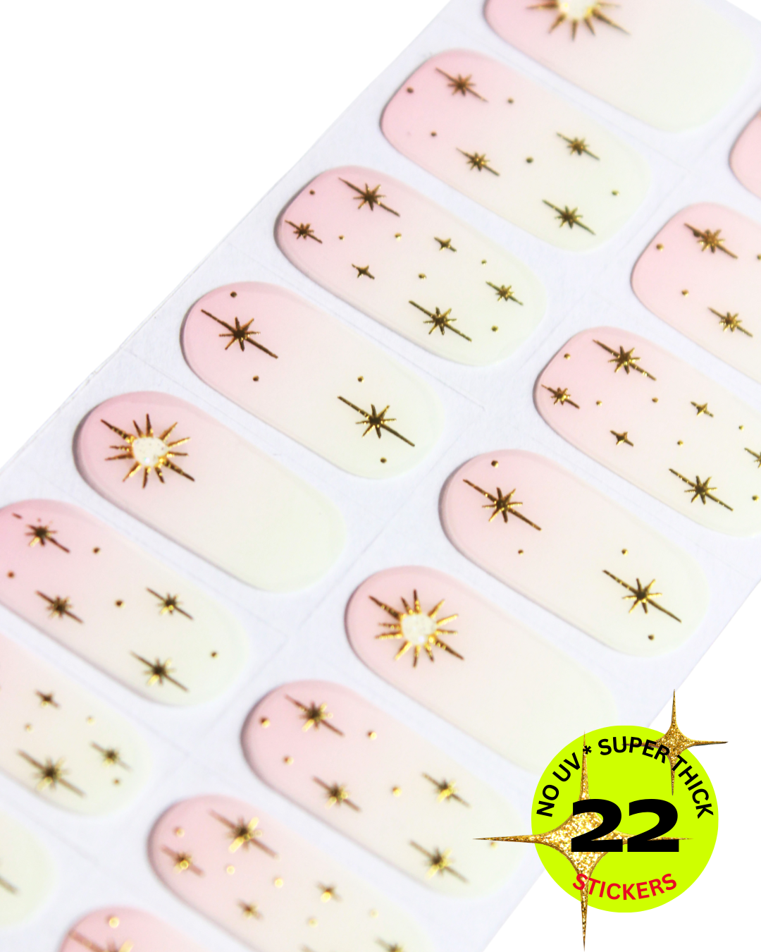 “Sheet of pink gradient nail wrap decorated with small gold star designs”