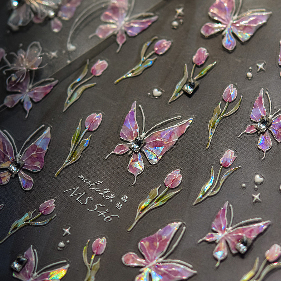 Iridescent butterfly and flower stickers on a dark background 