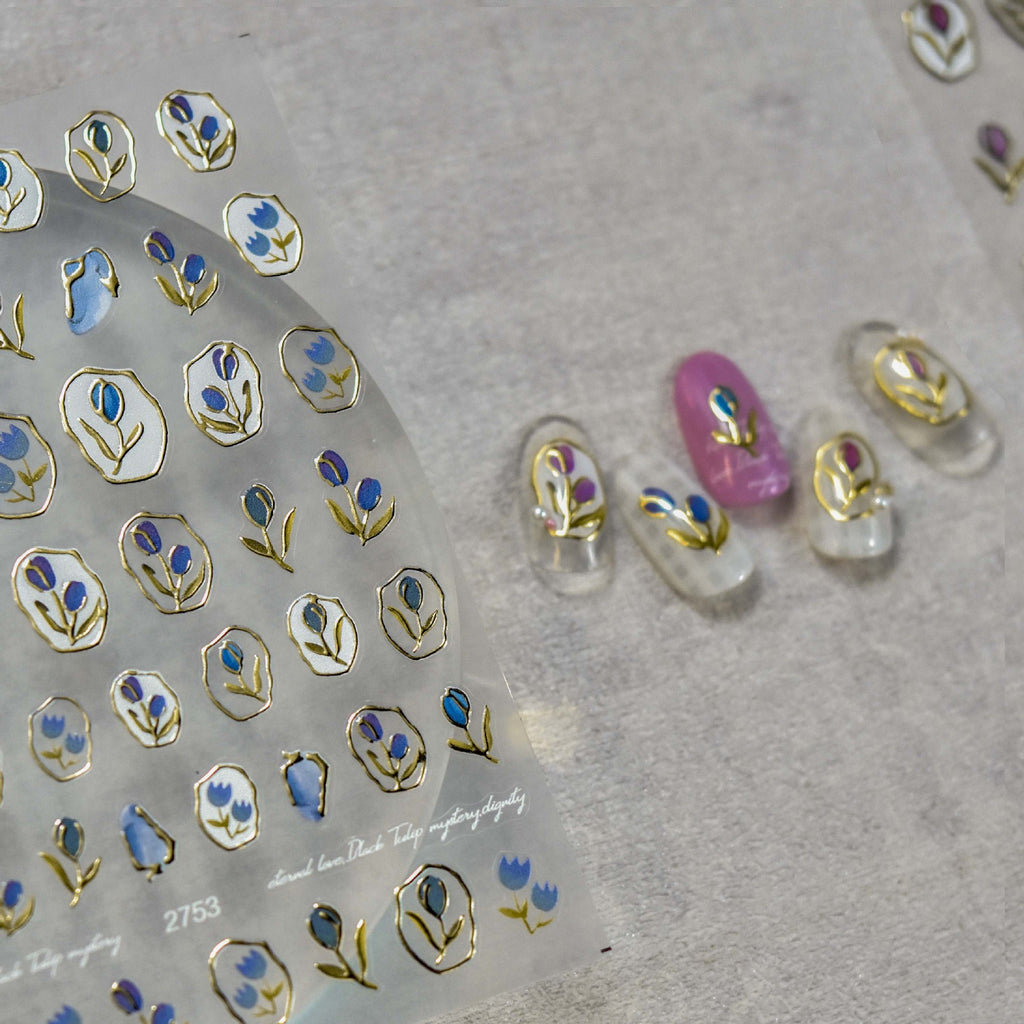 Blue  tulip nail art stickers with gold outline shown with decorated sample nails.
