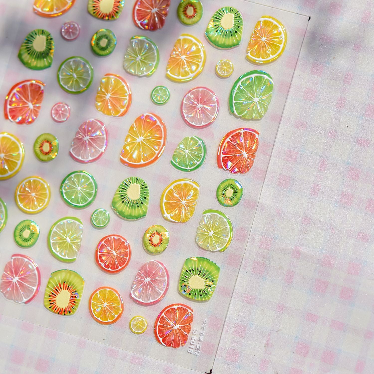 Colorful fruit slice stickers on a checkered background