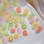Colorful fruit-shaped stickers on a white surface