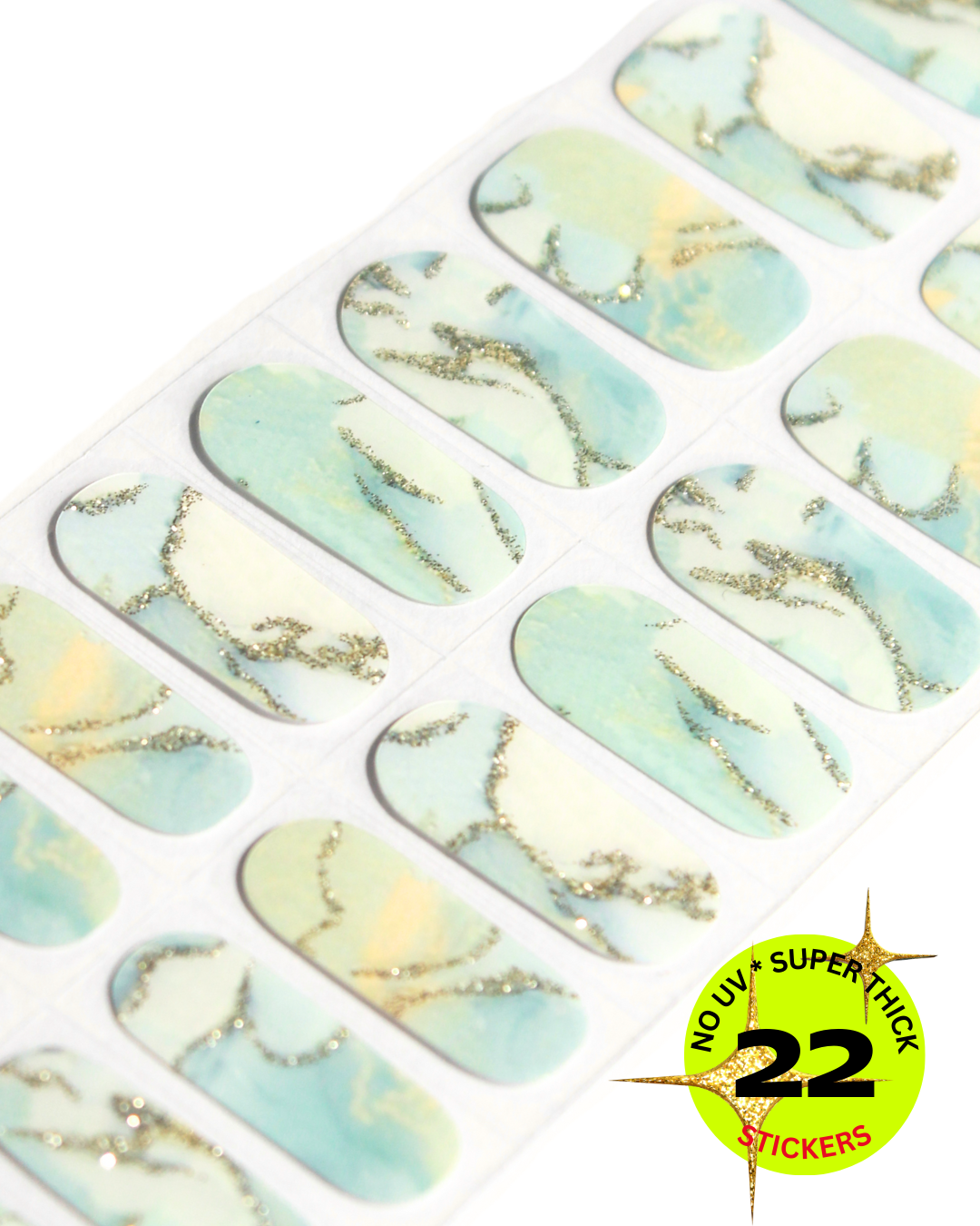 “Sheet of aqua and cream marble-style nail stickers with gold accents”