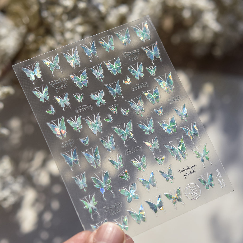 Sheet of butterfly stickers held by a hand with a blurred natural background