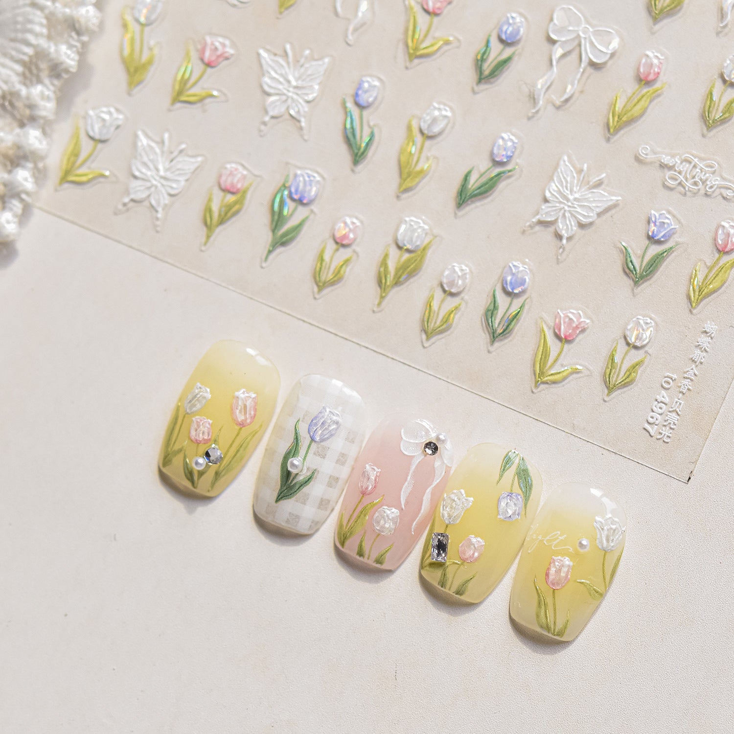 Nail art stickers with floral design and matching nail stickers on a light background
