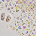 Floral nail art stickers on a white surface with nail samples.