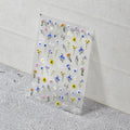 Sheet of small floral stickers on a textured surface