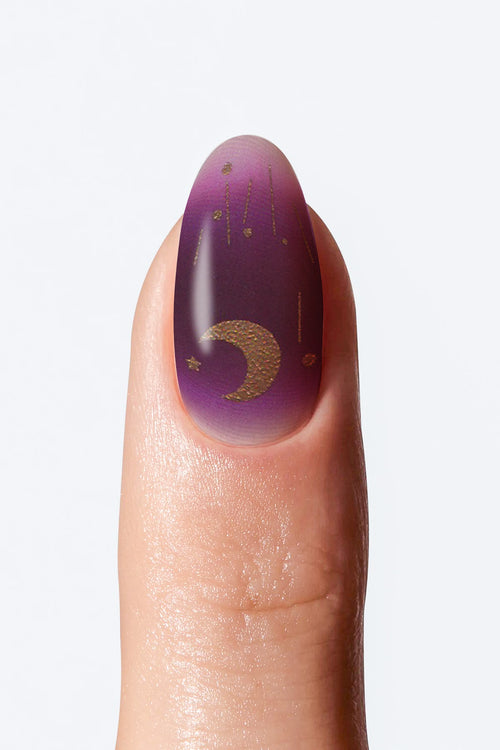 Purple gradient nail wrap with gold moon and star accents