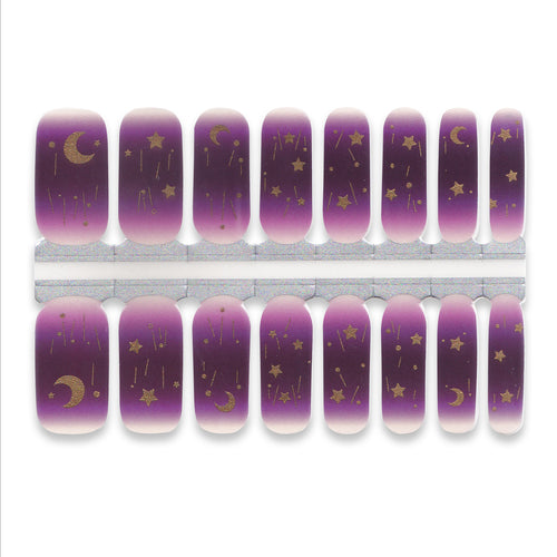 Purple nail wraps with gold moon and star designs on a white background