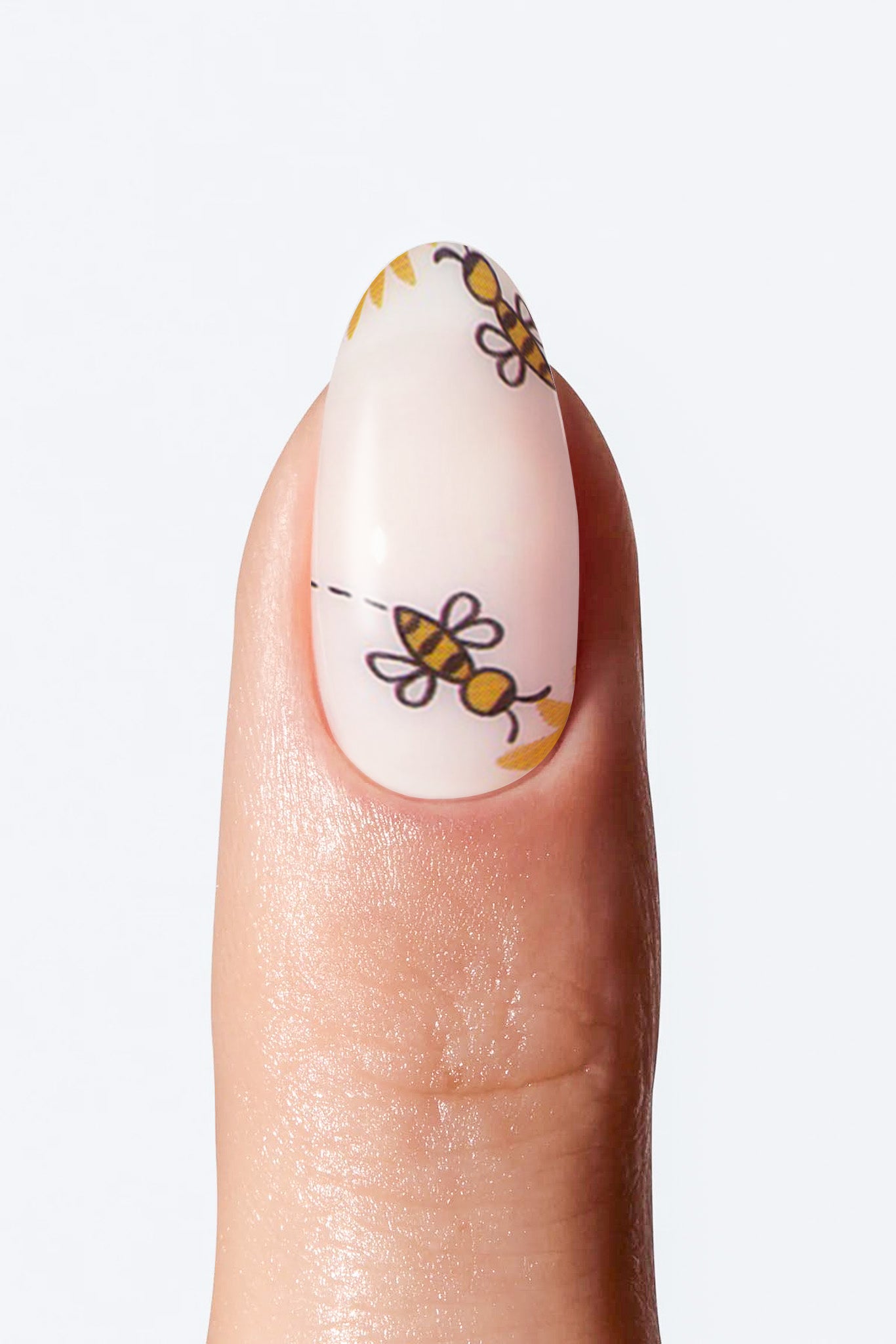 Nail with bee-themed nail art on a white background