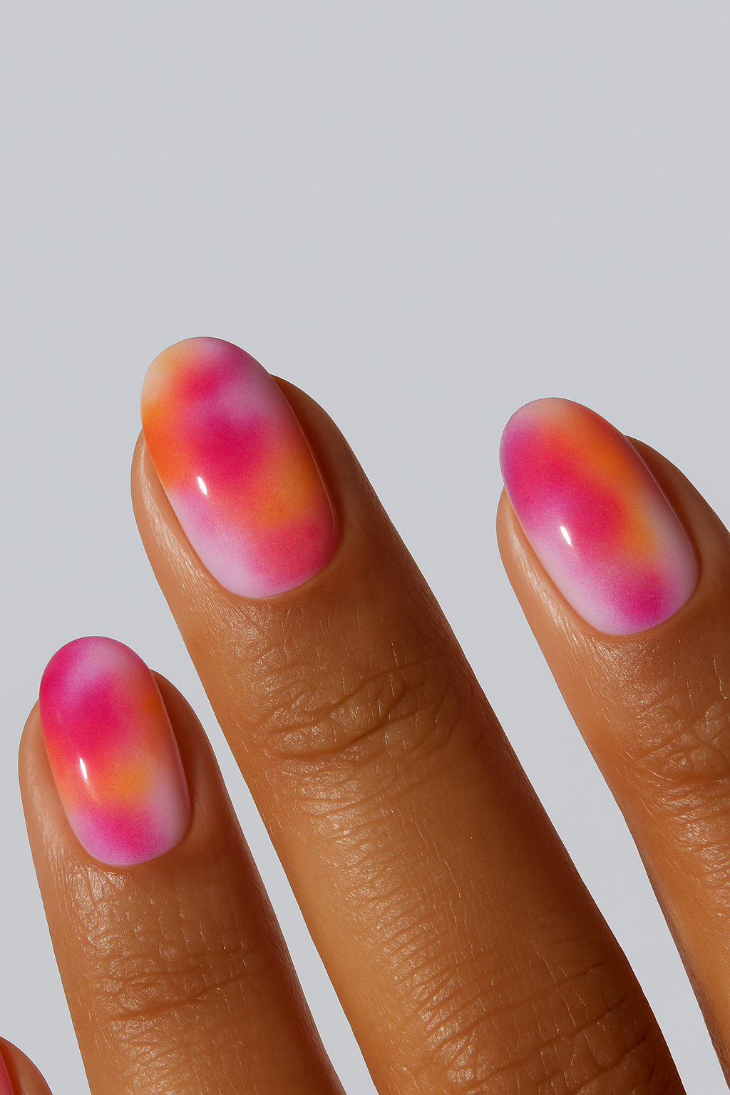 Sunset aura nail wrap in pink and orange gradient tones.