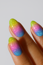 Multicolored glittery nail design on a neutral background