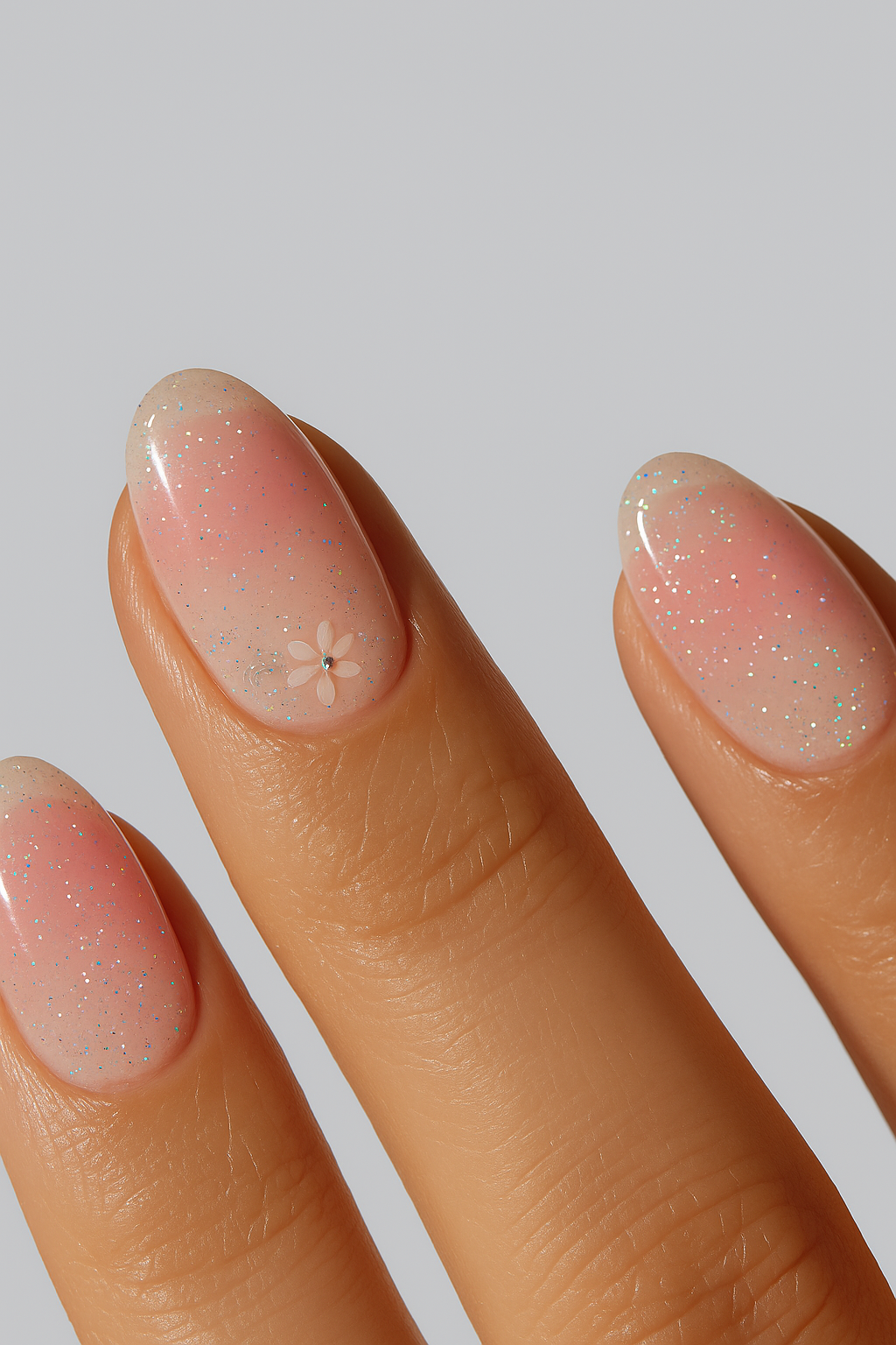 Peach glitter nail wrap manicure with delicate floral detail.