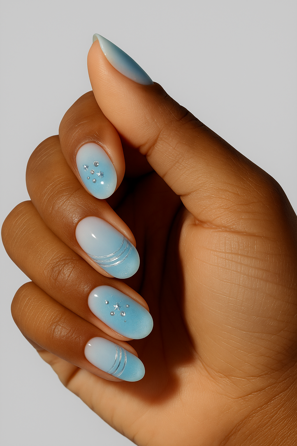 Hand with light blue nail wrap in a neutral background