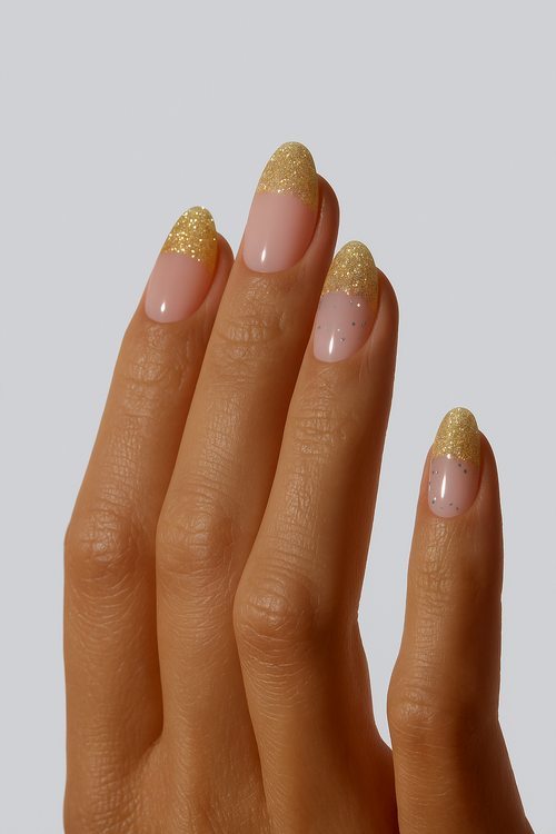 Nude nail wraps with gold glitter French tip design on hand