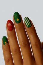 Christmas-themed nail wraps with red, green, star and snowflake manicure”
