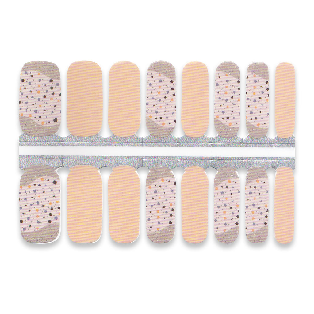 Sheet of nude nail wraps featuring small speckled dots across the surface