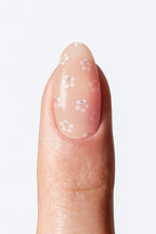 Nail with floral nail art on a light background
