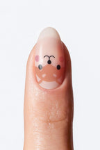 Adorable fox-themed nail wrap featuring playful fox illustrations, on single nail.