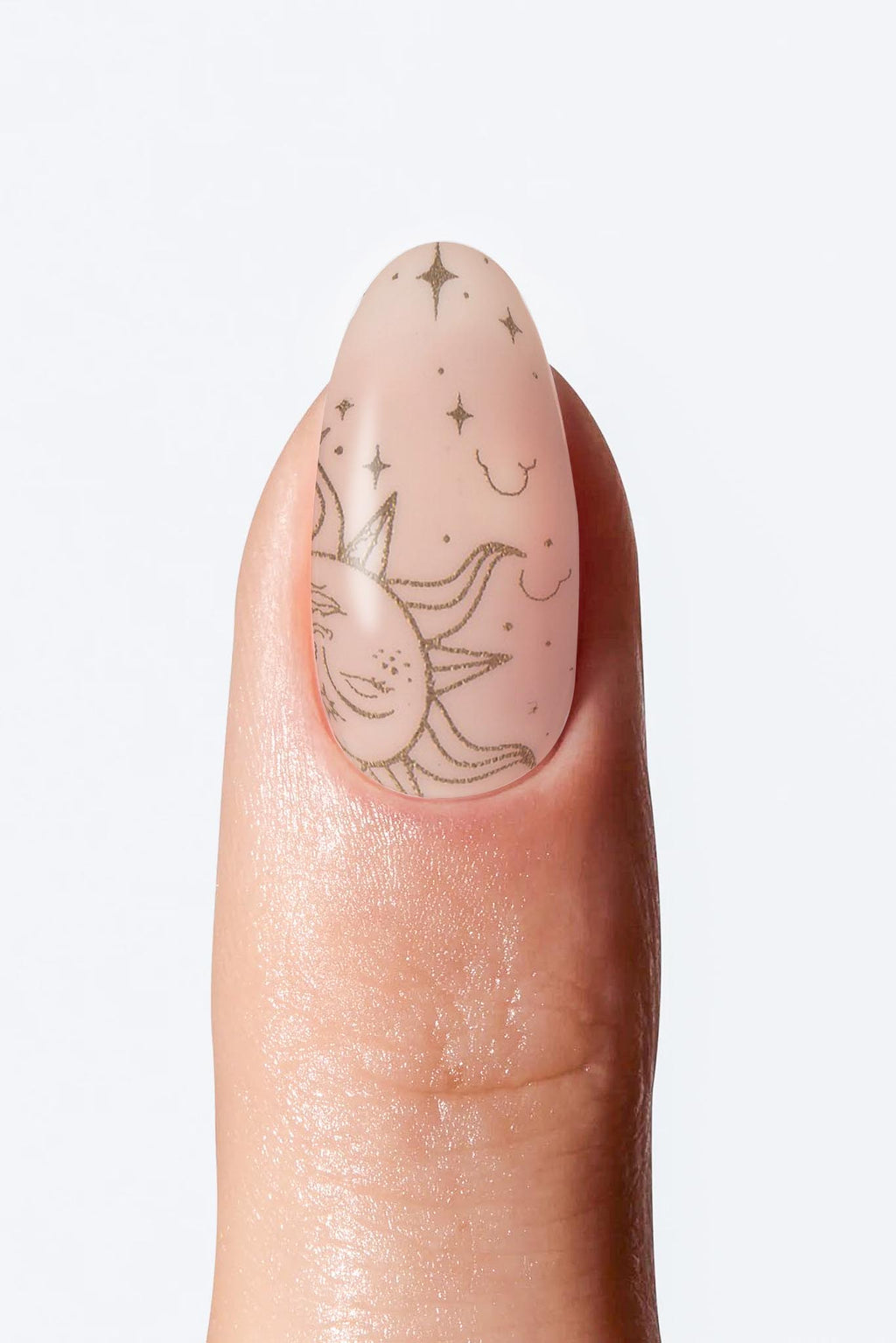 Sheer nude nail wrap manicure with delicate sun and star art.
