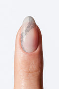 Nail with a silver and white design on a white background