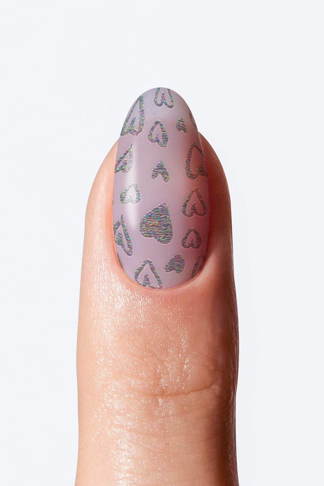 Close-up of nail with muted purple base and small shiny heart shapes print .