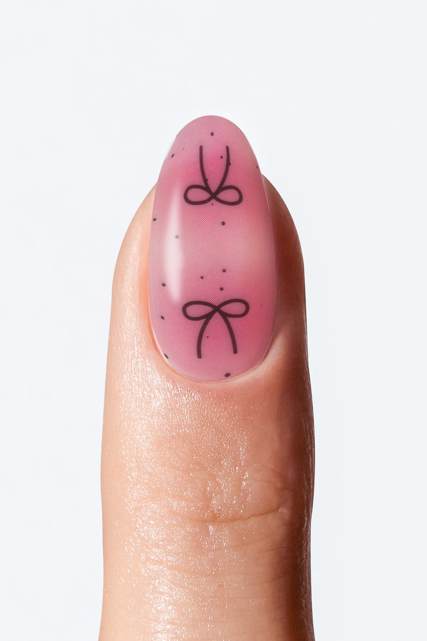 Pink gradient nail wrap with black bow design”