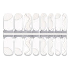 Set of white nail wraps with abstract designs on a white background