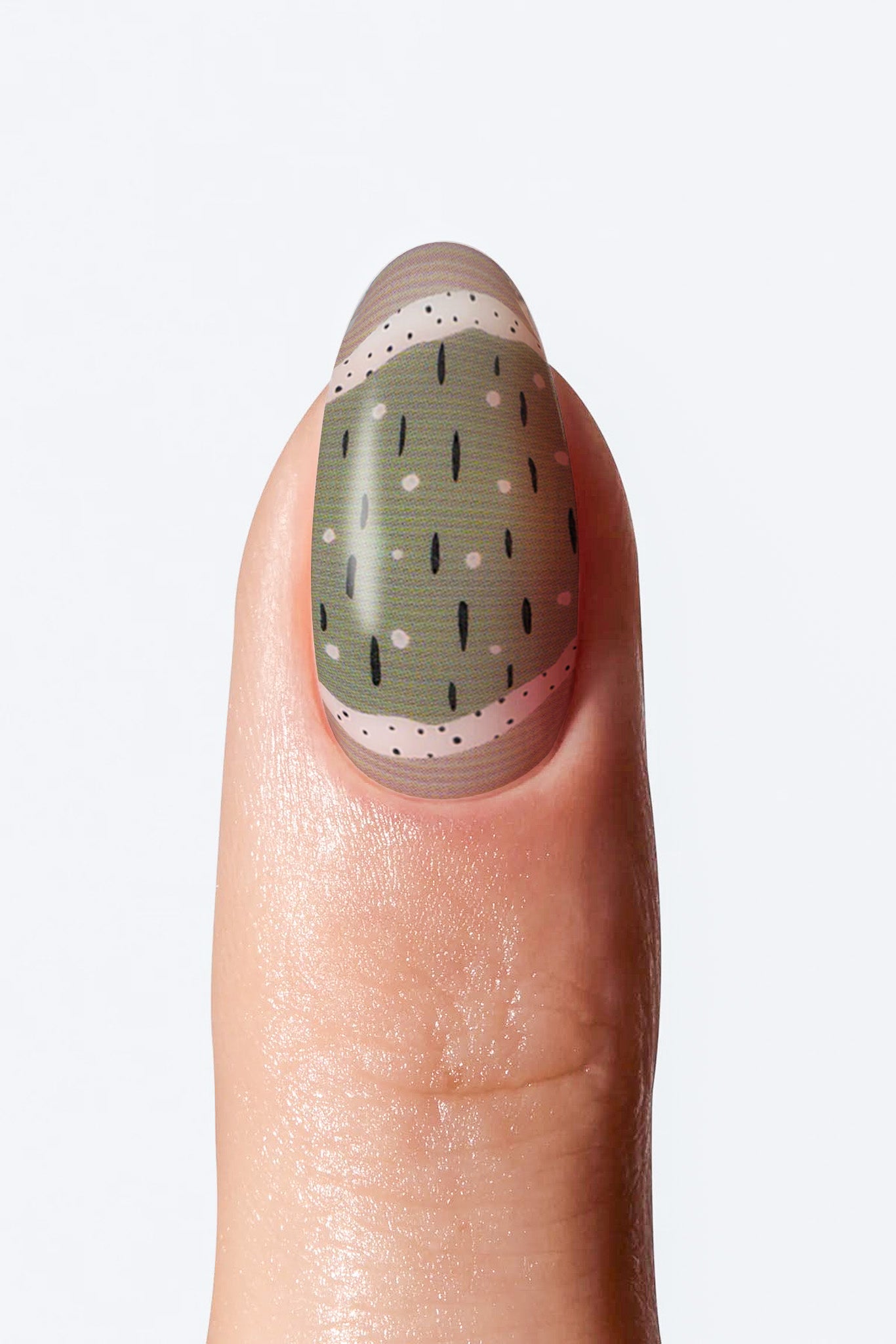 Close-up of nail with muted green base and small black dot details