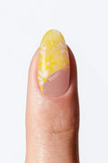 Yellow floral nail wrap manicure with white floral print and nude base.