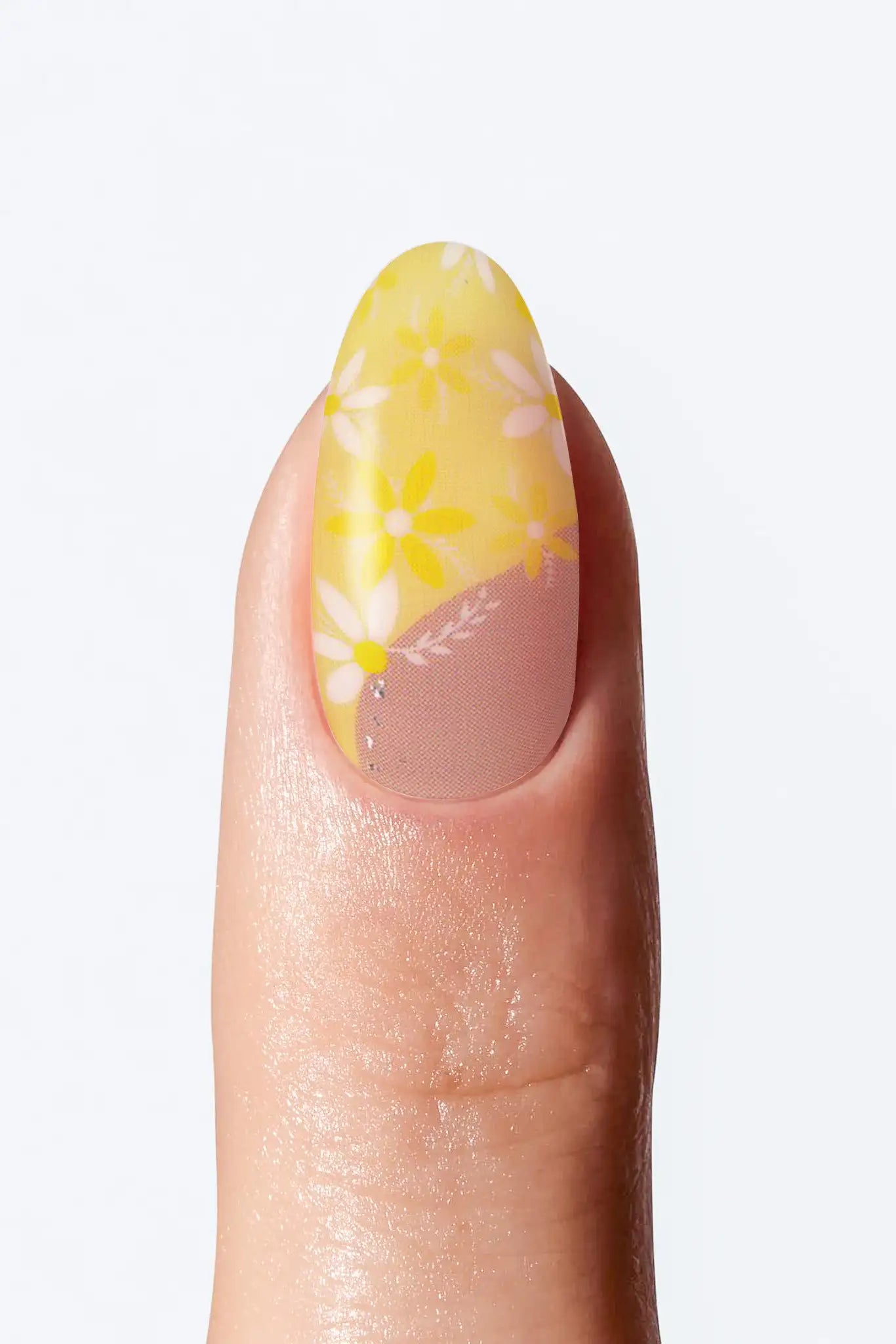 Yellow floral nail wrap manicure with white floral print and nude base.