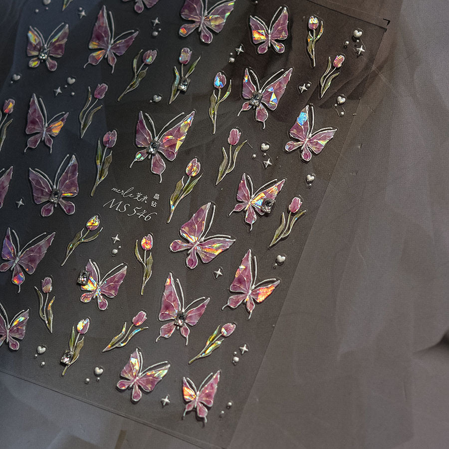 Sheet of butterfly and flower stickers with rhinestones on a dark background