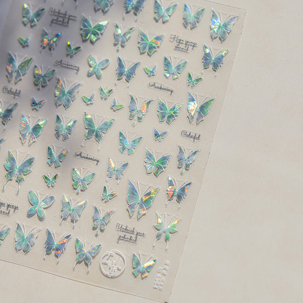 Sheet of holographic butterfly stickers on a plain background