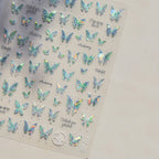 Sheet of holographic butterfly stickers on a plain background