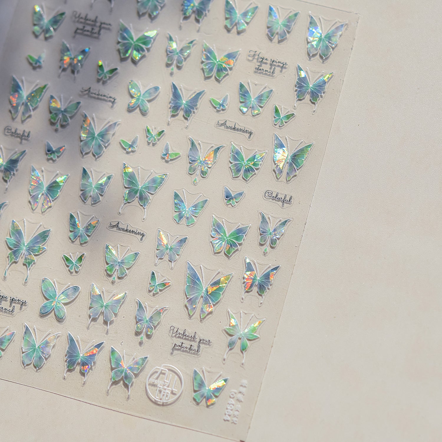 Sheet of holographic butterfly stickers on a plain background
