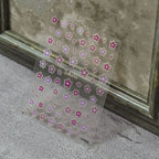 Transparent sheet of pink and purple sakura flower nail art stickers with gold outline.