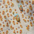 Nail art with sunflowers and butterflies on a matching background