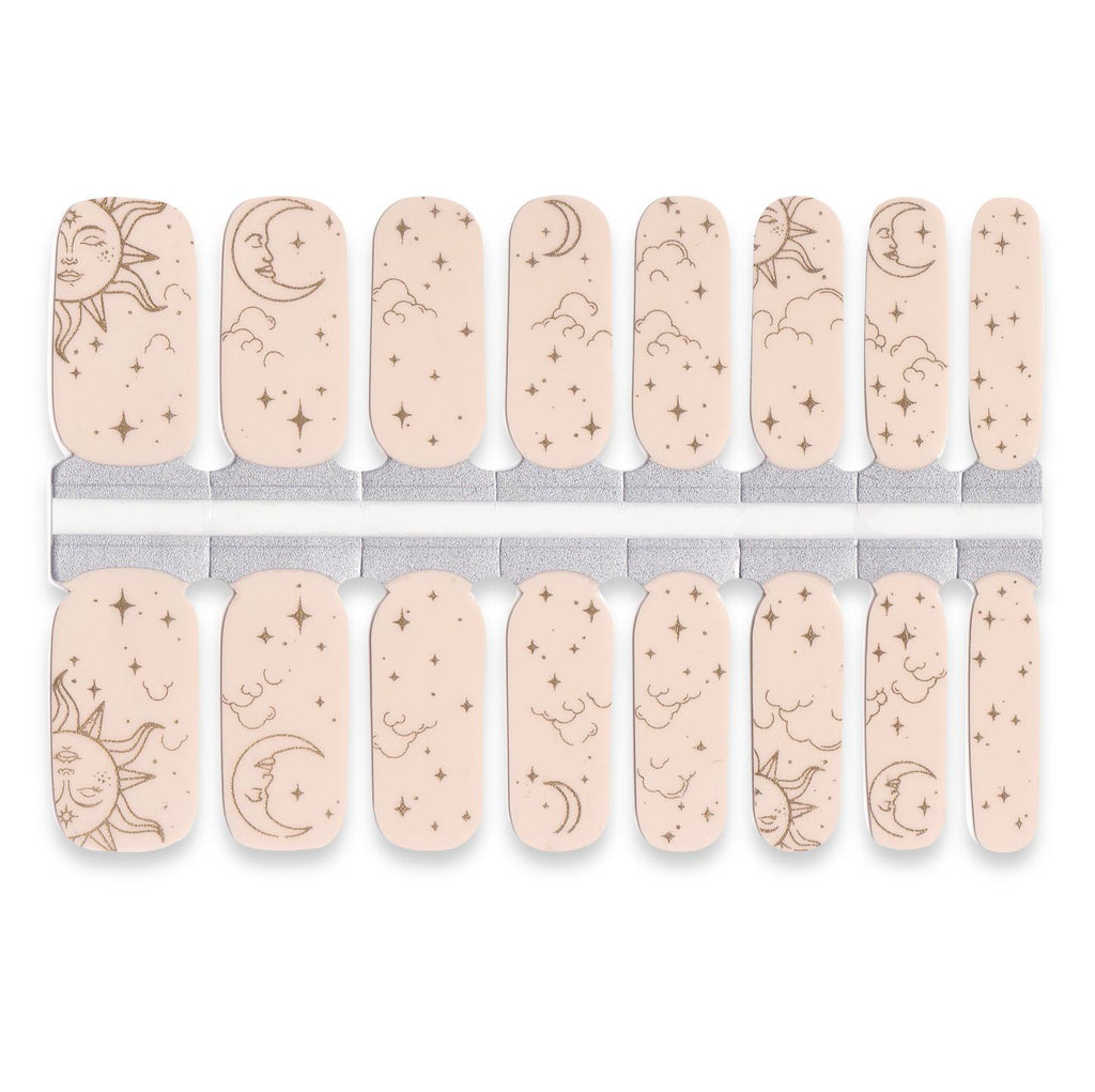 Celestial nude nail wraps featuring sun, moon and star illustrations on soft beige base.