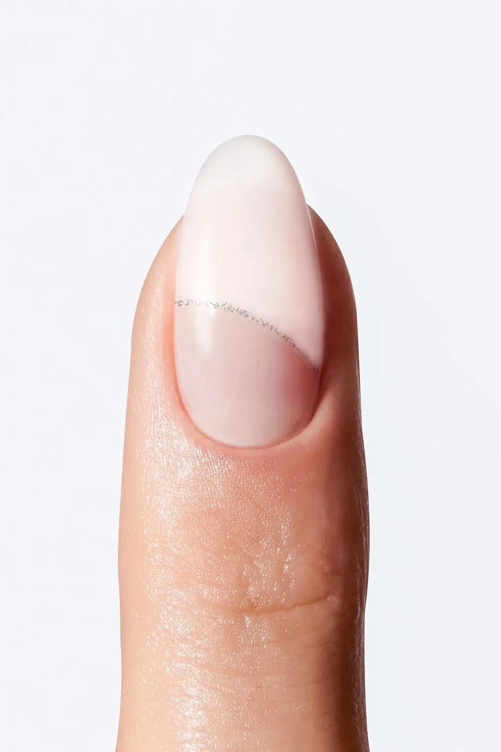 Minimal nude nail wrap manicure with soft white tip and fine silver line detail.